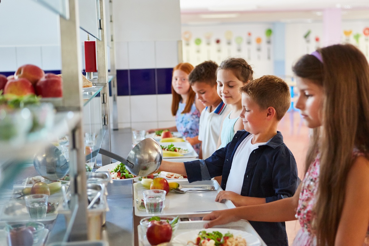 Students taking food while standing in line