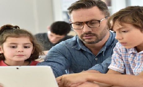 Teacher with students in class using digital tablet