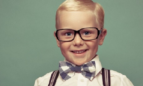 Cheerful smiling funny boy on a green background.